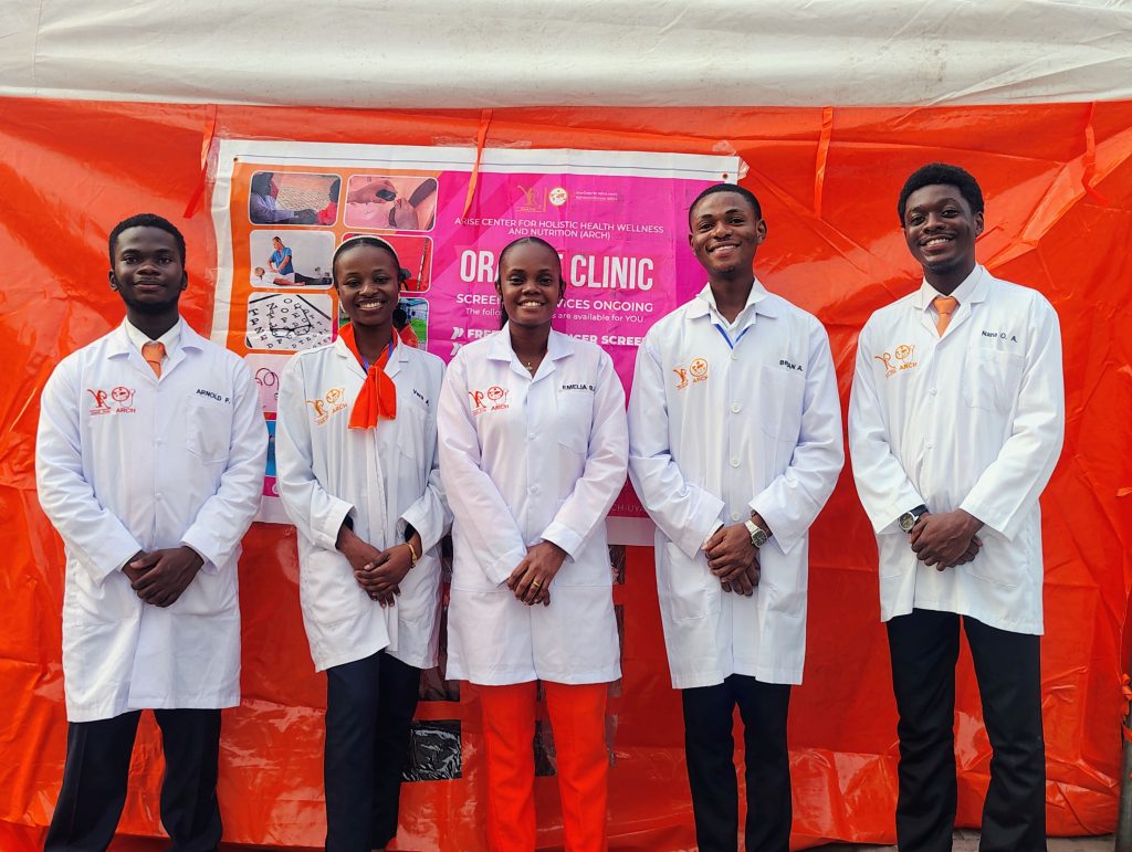 Healthpreneurs team members in white coats at the Orange Clinic.