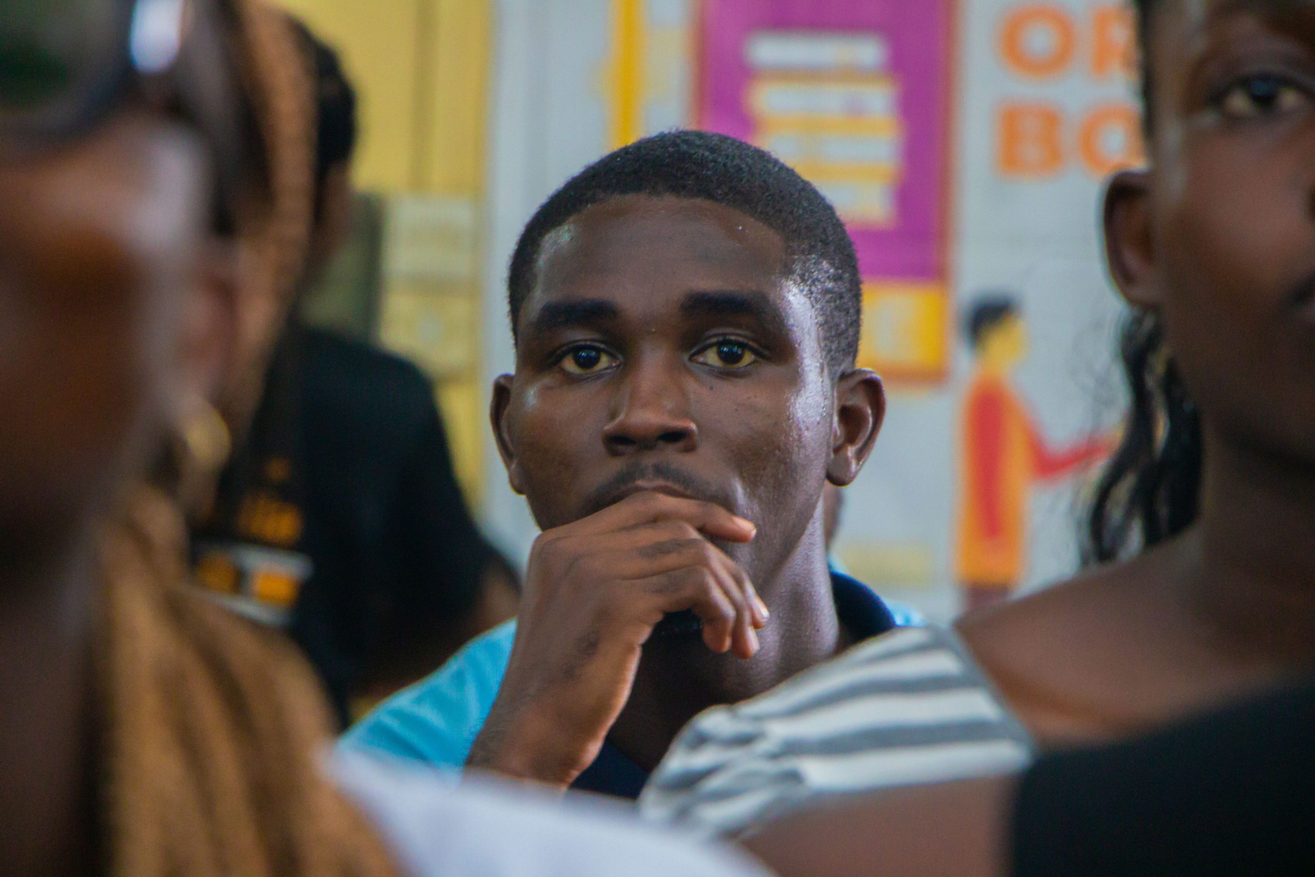 Participant listening thoughtfully during a conference session