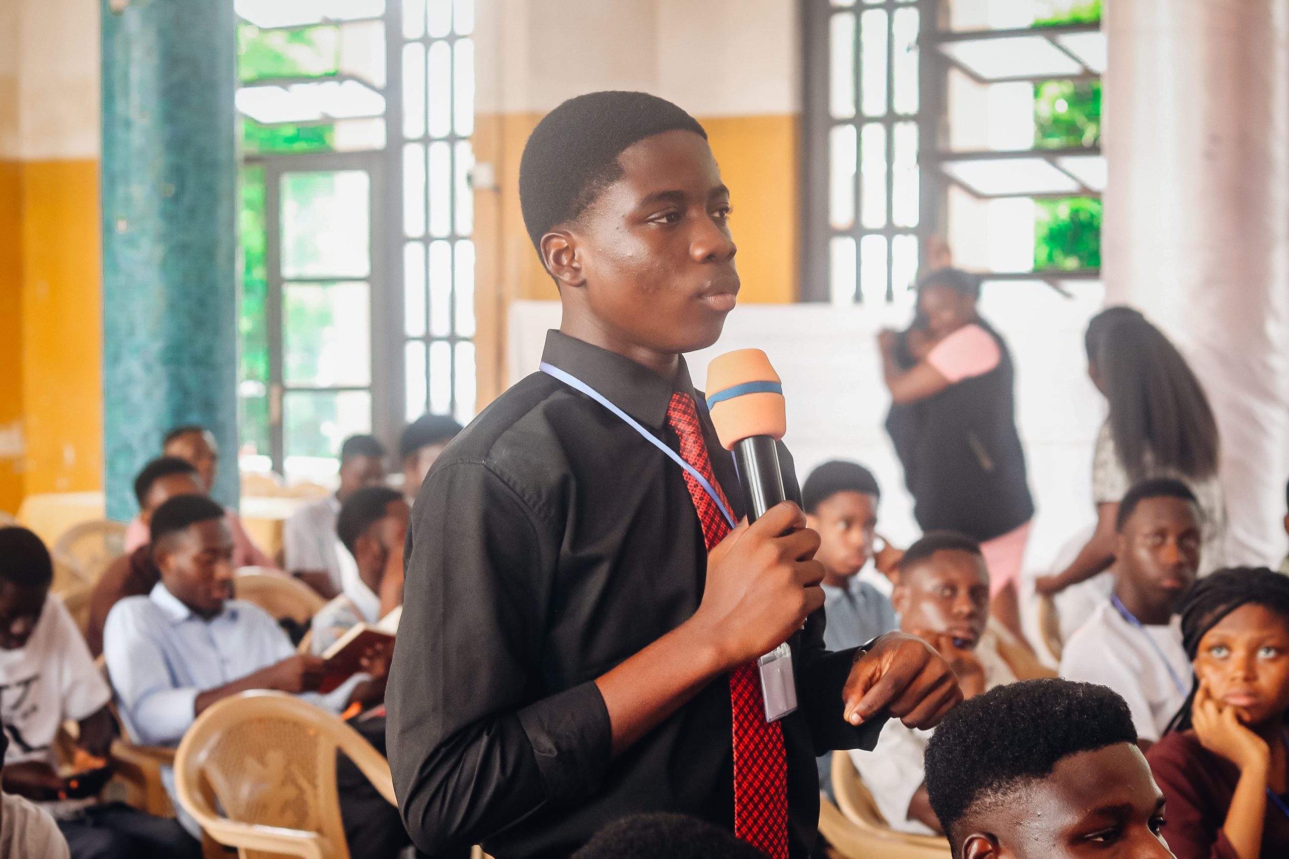 Young participant speaking into a microphone
