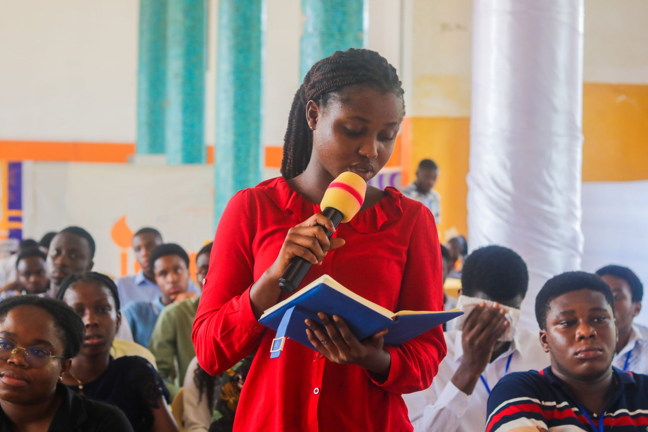 Young woman speaking into a microphone during a session