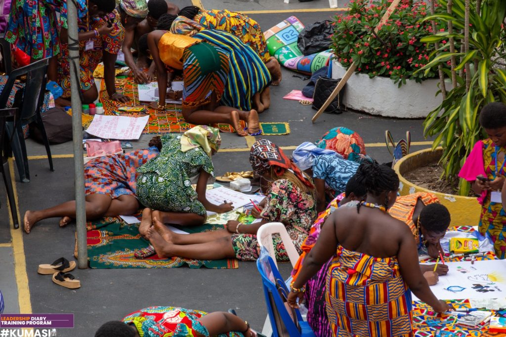 Participants work together on illustrated visions for Africa during a group drawing activity.
