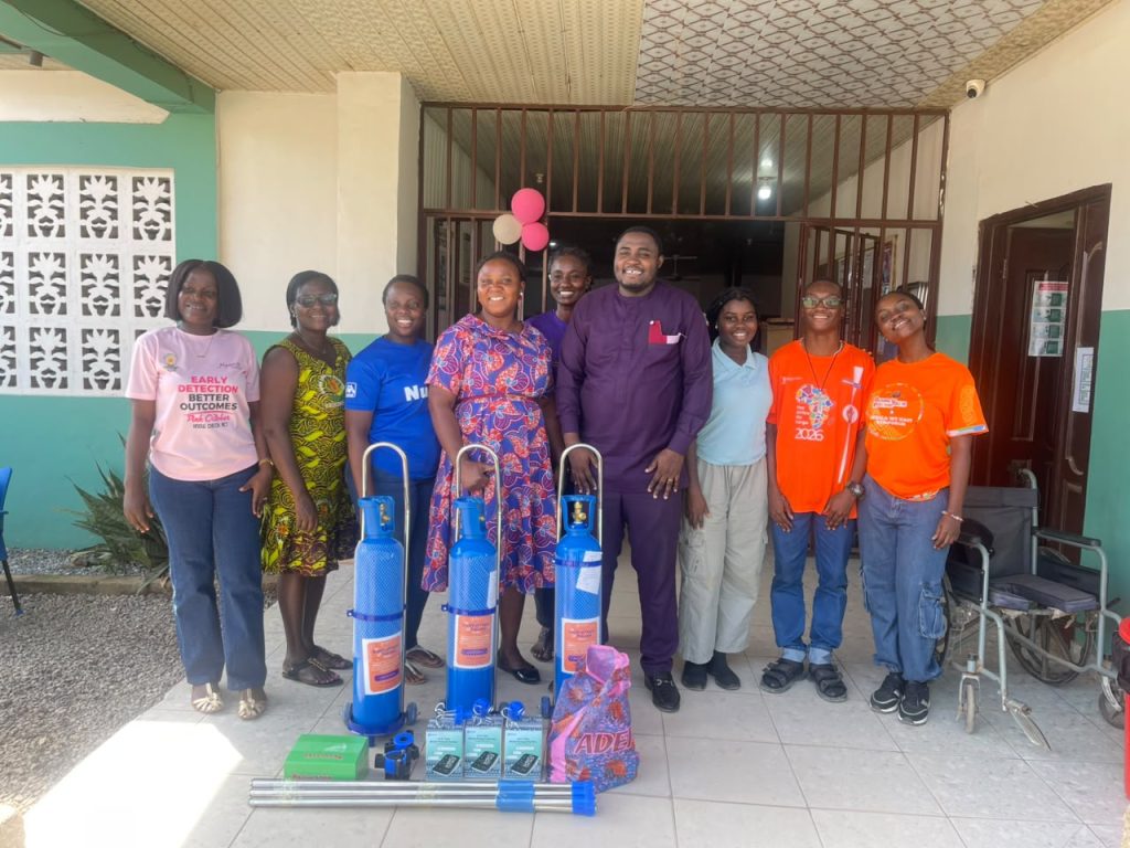 Team Heshima and health-centre representatives with donated oxygen cylinders and other medical equipment.