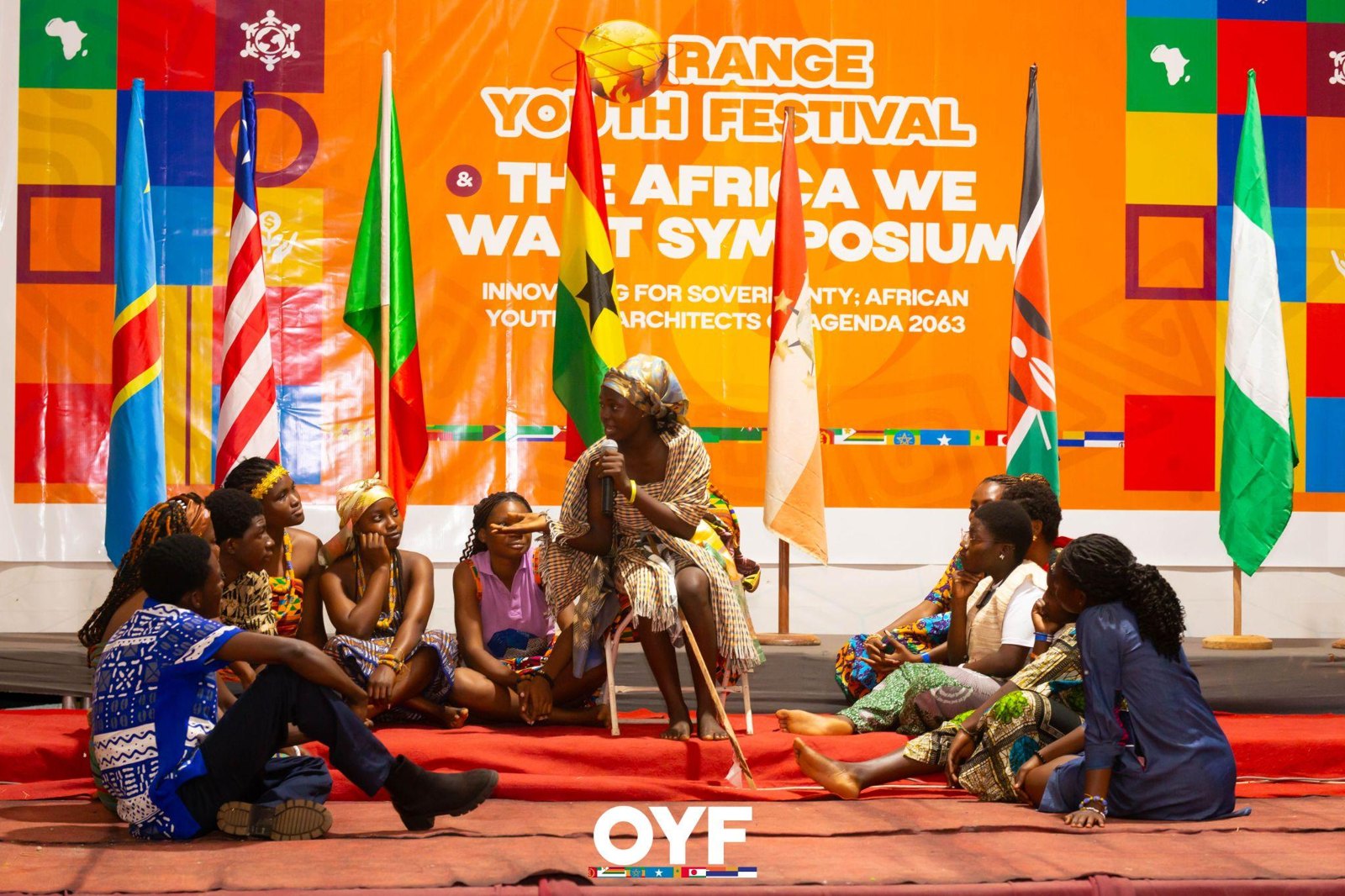 An ensemble presenting a theatrical scene on the Orange Youth Festival stage