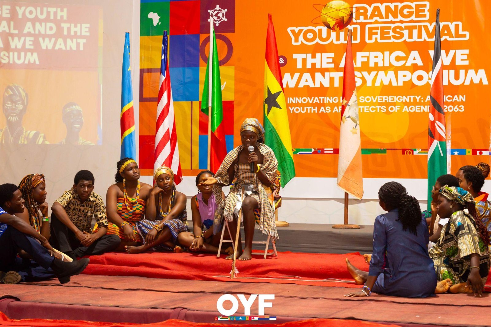 Performers gathered around a central storyteller during an ensemble scene